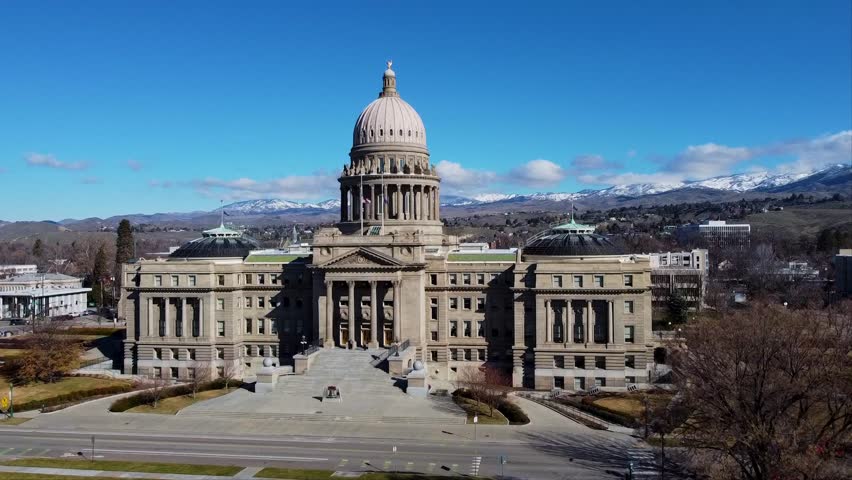 Aerial drone shot of the Idaho State Capitol in downtown Boise, showcasing its iconic dome, surrounding cityscape, and historic architecture, ideal for tourism, government, or promotional projects