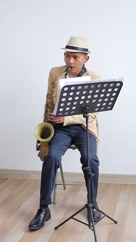 Full Length Video Of Young Man Musician In A Suit And Fedora Hat Playing On Saxophone