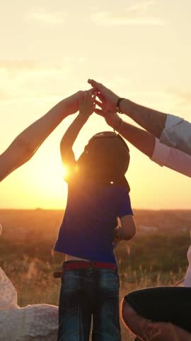 Happy family, kid playing of comfortable home with their hands at sunset. Happy family father mother child son dream to buy house. Family home, parents play with their child son Dad kid mom silhouette