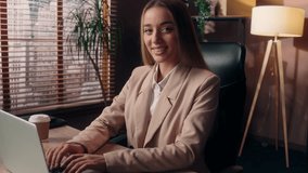 Glad happy cheerful Caucasian business woman female smiling girl businesswoman employee entrepreneur working online laptop computer typing internet work freelance looking at camera smile inside office - Powered by Shutterstock - Get 15% off with code: PIKWIZARD15