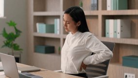Tired sick Asian business woman Japanese Chinese girl female businesswoman unhealthy Korean overworked worker lady suffering back pain computer laptop sitting work massaging painful backache in office - Powered by Shutterstock - Get 15% off with code: PIKWIZARD15