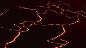 Close up of Iceland lava field with molten magma flowing as rivers on dark surface at night. - Powered by Shutterstock - Get 15% off with code: PIKWIZARD15