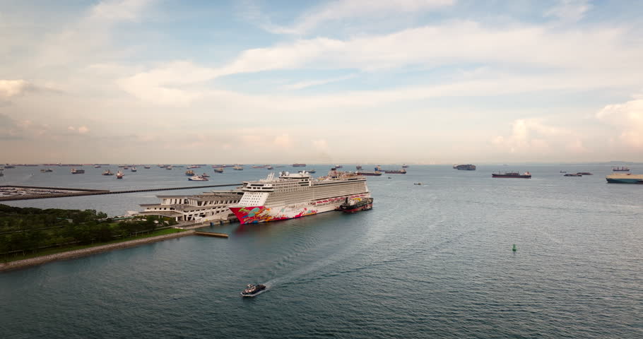 Genting Dream Cruise ship anchored in port of Marina Bay, Singapore, Asia. Aerial sideways and copy space