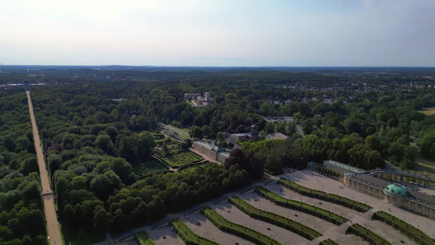 Sunny summer day Potsdam sanssouci Palace showing the beautiful green gardens and surrounding area. Beautiful aerial view flight tilt down drone