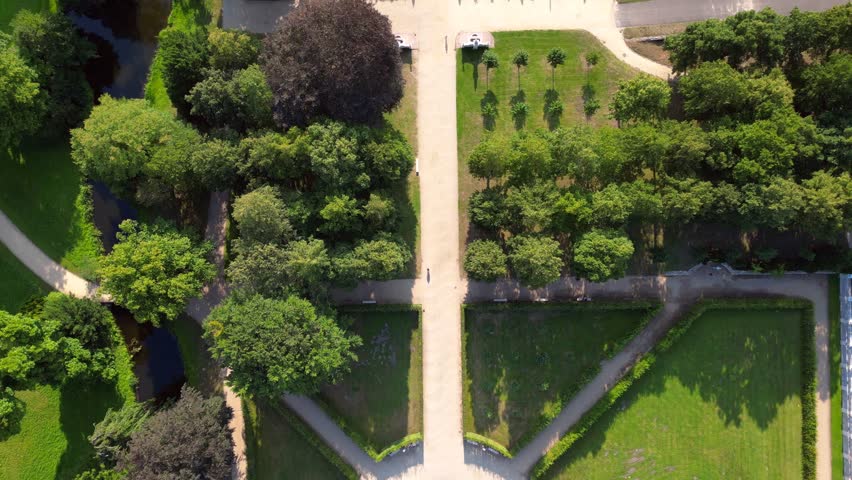 Sunny summer day Potsdam sanssouci Palace showing the beautiful green gardens and surrounding area. Marvelous aerial view flight tilt up drone