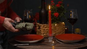 Person setting table for St. Valentines Day celebration. Preparing for romantic candlelight dinner for two. - Powered by Shutterstock - Get 15% off with code: PIKWIZARD15