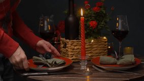 Person setting table for St. Valentines Day celebration. Preparing for romantic candlelight dinner for two. - Powered by Shutterstock - Get 15% off with code: PIKWIZARD15