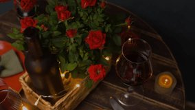 Romantic candlelit dinner with red wine. Table is decorated with red roses and candles. Celebrating Valentine's Day. - Powered by Shutterstock - Get 15% off with code: PIKWIZARD15
