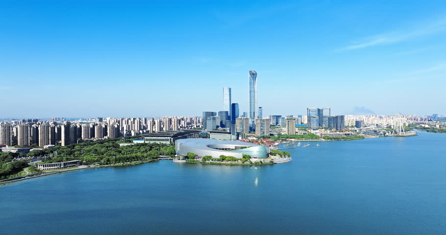Aerial shot of modern city commercial buildings skyline and lake in Suzhou, China