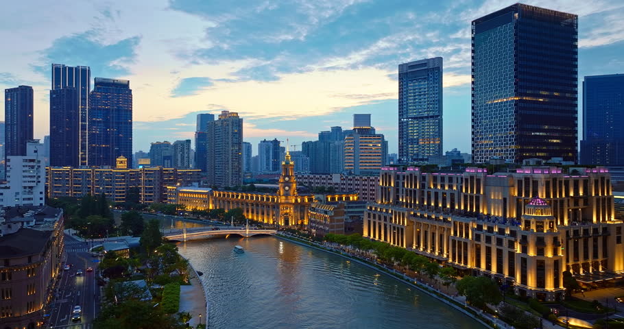 Aerial shot of commercial buildings and river at sunset in downtown Shanghai, China