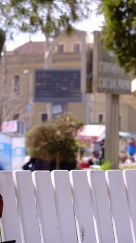 Shaking hands with a friend who comes near a young black man sitting on a bench, black teen and white teen chatting