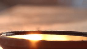 Calm water in a clay pot, with cool sun reflection and lens flare, at sunset. - Powered by Shutterstock - Get 15% off with code: PIKWIZARD15