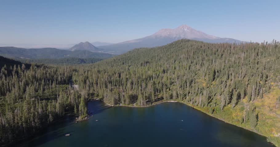 Aerial pullback across Castle Lake in Shasta California USA with mountain and black butte centered