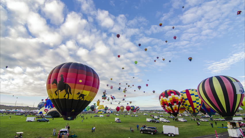 Balloon Fiesta Mass Ascension Timelapse. Hot Air Balloons. Lift off, take off, Albuquerque International Balloon Fiesta, Sunrise, Clouds.