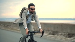 Commuting Businessman Cycling Commuter On Bicycle To Work. Cyclist Commute Lifestyle. Businessman Riding Bike City.Cyclist Commuting Work On Eco Transport.Elegant Businessman Cyclist Commuter In Suite - Powered by Shutterstock - Get 15% off with code: PIKWIZARD15