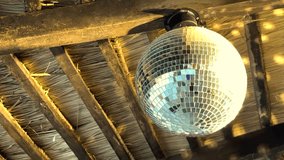 Spinning disco ball under wooden ceiling beams - Powered by Shutterstock - Get 15% off with code: PIKWIZARD15