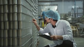 Production control supervisor inspects and controls the operation of each step in the production line of a canned fish factory - Powered by Shutterstock - Get 15% off with code: PIKWIZARD15