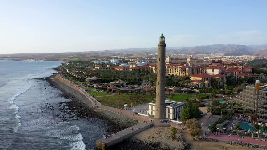 Lighthouse of Maspalomas at Gran Canaria Island known as Faro de Maspalomas at sunset. Seascape with lighthouse and Maspalomas beach. Gran Canaria, Canary Islands, Spain