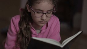 Portrait Child Reading Book Concentrated on Story Sitting on Floor at Home. Development of Kids and Education Literature. Girl Lying on Floor in Bedroom at Home, Reading Book. Learning Relax Hobby. - Powered by Shutterstock - Get 15% off with code: PIKWIZARD15