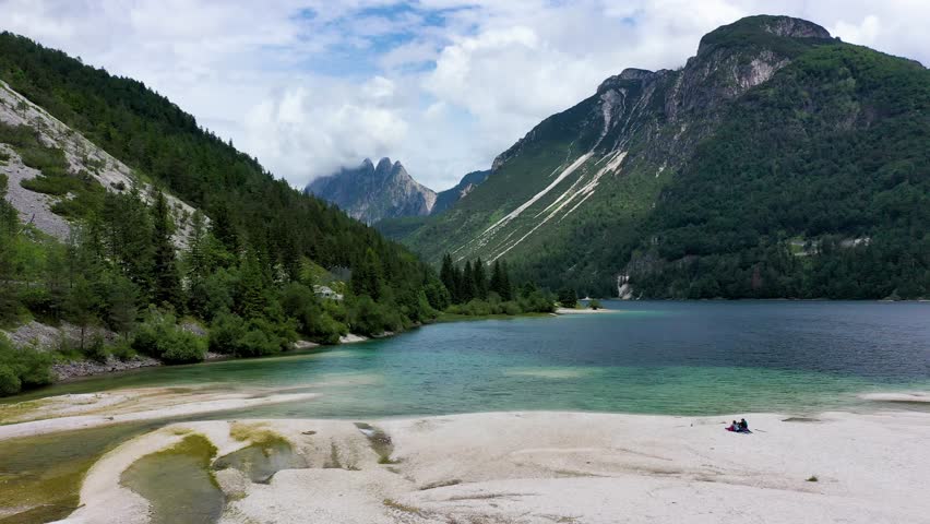 View to Julian Alps mountains above Predil lake in Italy with small lake. Predil Lake, Friuli Italy (Lago del Predil), beautiful alpine lake in north Italy near the Slovenian border, Italy.