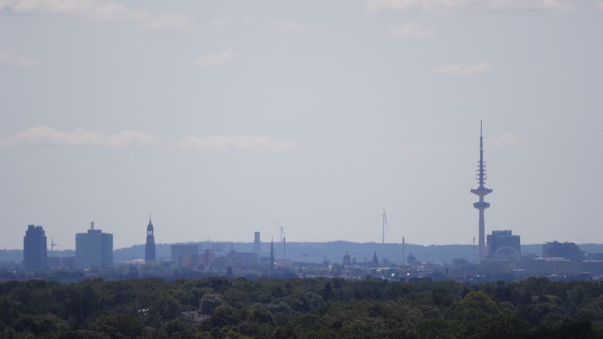 Passenger Plane Arriving in Hamburg with Iconic Skyline and Landmarks in the Background