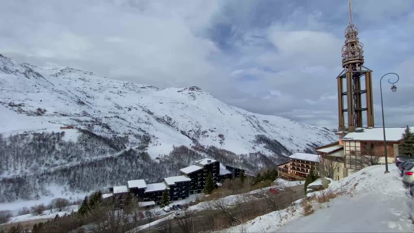 Winter footage of the mountains, ski pistes, snowy slopes in Les 3 Vallees in France. Skiing and snowboarding in the Alps.