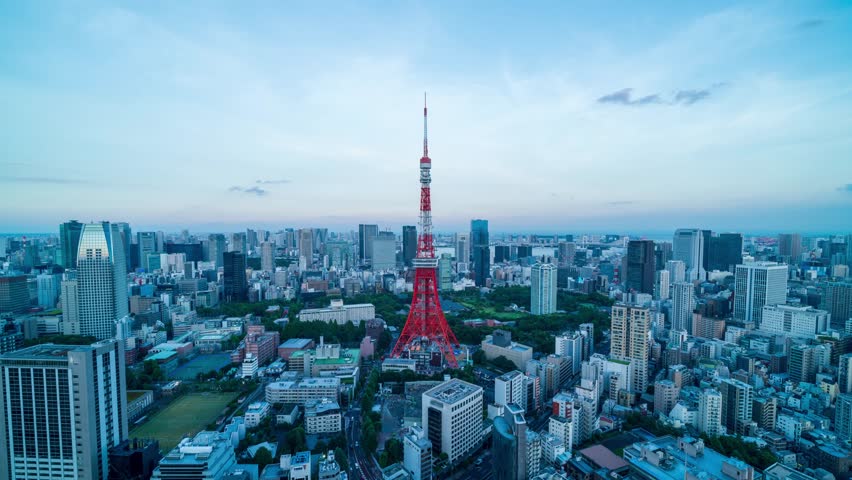 4k timelapse of cityscape of Tokyo at sunset with Tokyo Tower in the center of the frame,from dusk to night.high point of view time lapse of modern urban town business buildings and skyscrapers