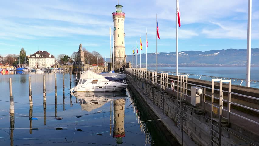 Harbor of Lindau on lake Constance with lighthouse and lion statue on a sunny day in winter, Germany, Bavaria