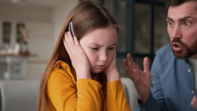 Anxious guilty Caucasian daughter schoolgirl child closing ears annoyed dad guy male man screaming furious parent father scolding fearful little girl kid at home family abuse conflict argue punishment - Powered by Shutterstock - Get 15% off with code: PIKWIZARD15