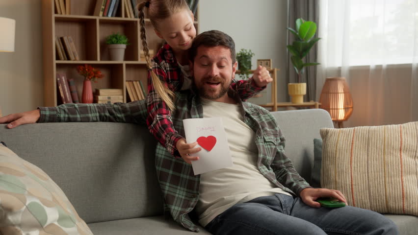 Caucasian child daughter girl surprise man dad male at home guy father smile receive gift handmade holiday card for Father's Day family carefree little kid schoolgirl congratulation parent celebration - Powered by Shutterstock - Get 15% off with code: PIKWIZARD15
