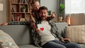 Caucasian child daughter girl surprise man dad male at home guy father smile receive gift handmade holiday card for Father's Day family carefree little kid schoolgirl congratulation parent celebration - Powered by Shutterstock - Get 15% off with code: PIKWIZARD15