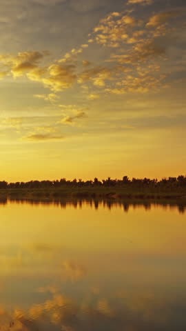 Beautiful landscape with sunset over river, timelapse. Vertical video