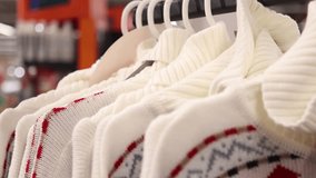 A colorful marketplace displays various cozy knit sweaters, featuring unique patterns and textures, inviting shoppers to explore the perfect winter wardrobe. Discover the latest styles today. - Powered by Shutterstock - Get 15% off with code: PIKWIZARD15