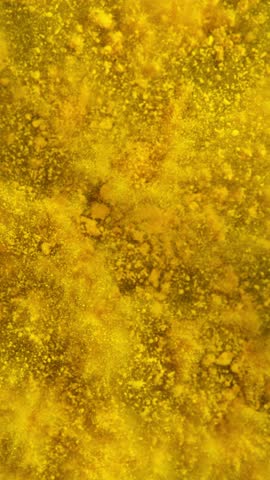 Super Slow Motion of Yellow Powder Explosion. Filmed on High Speed Cinema Camera, 1000fps. Vertical Aspect Ratio.