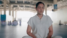 Finding Inner Peace. Woman meditating in a serene industrial setting, a moment of tranquility amid the concrete and steel.   - Powered by Shutterstock - Get 15% off with code: PIKWIZARD15