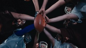 American Football Players Joining Hands in circle Concept of United Team Spirit in Action - Powered by Shutterstock - Get 15% off with code: PIKWIZARD15