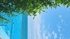Vertical, Luxury Resort Hotel with Infinity Swimming Pool with Beautiful Sea View Blue Sunny Sky and White Clouds, Slow Motion Nobody Relax Beauty Pool Beach Ocean Blue Sky, Travel., Nobody Relax. - Powered by Shutterstock - Get 15% off with code: PIKWIZARD15