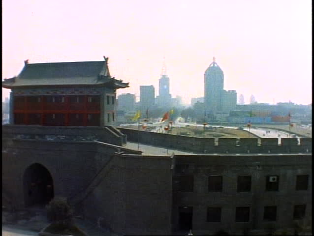 CHINA, 1999,  Xian, City Wall and ancient building, city in background, wide shot, silhouette