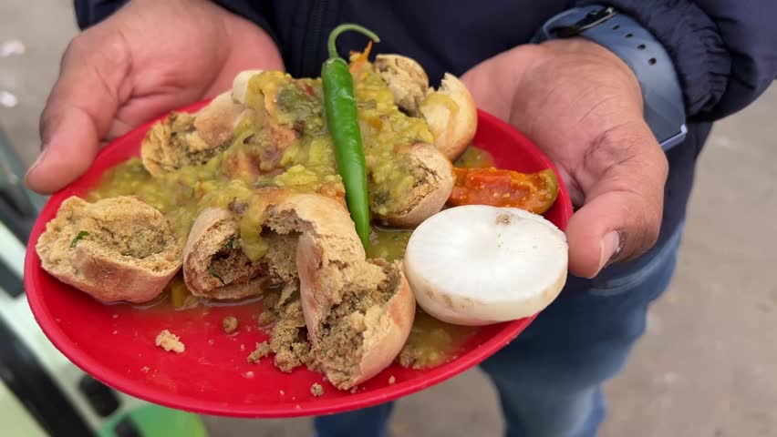 Litti chokha served with green chili and tomato by a roadside stall in Ranchi, Jharkhand.