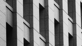 Black and white architectural facade with geometric repeating windows, minimalist design, structured concrete textures, close-up view of modern building exterior, abstract urban design - Powered by Shutterstock - Get 15% off with code: PIKWIZARD15
