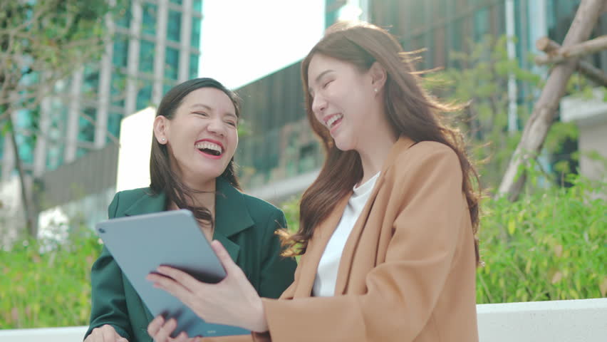 Financial advisor broker manager consulting investor client about digital investment at office meeting. Two bisinesswoman planing loan with digital tablet, talking, working together, - Powered by Shutterstock - Get 15% off with code: PIKWIZARD15