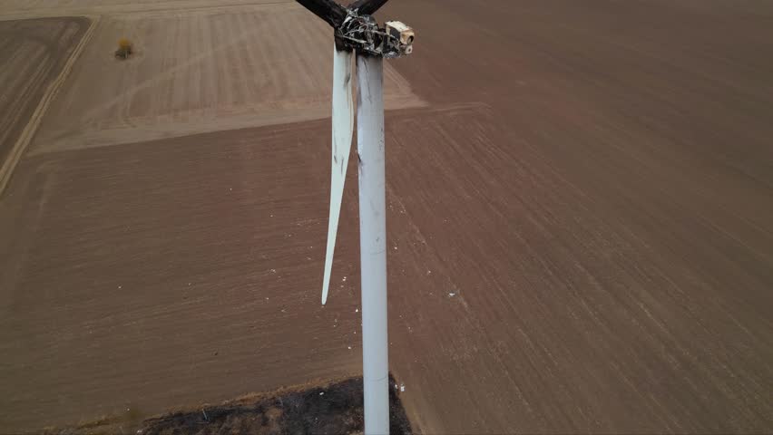 Close up footage of a burned down wind turbine generator. Lightning strike of windmill or overheating caused meltdown of power generator engine and mechanical system. Destroyed infrastructure Disaster