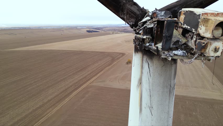 Close up footage of a burned down wind turbine generator. Lightning strike of windmill or overheating caused meltdown of power generator engine and mechanical system. Destroyed infrastructure Disaster