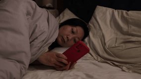 Sleepy Asian woman tired girl sleep nap rest at night home dark bedroom sleeping in bed with mobile phone scrolling smartphone addict gadget read social media yawning fall asleep nighttime. - Powered by Shutterstock - Get 15% off with code: PIKWIZARD15