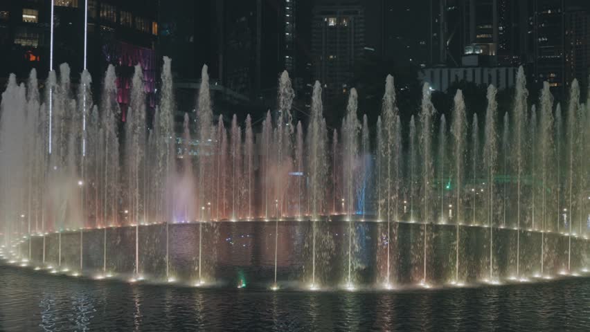 Illuminated dancing fountains at night in Kuala Lumpur, Malaysia
