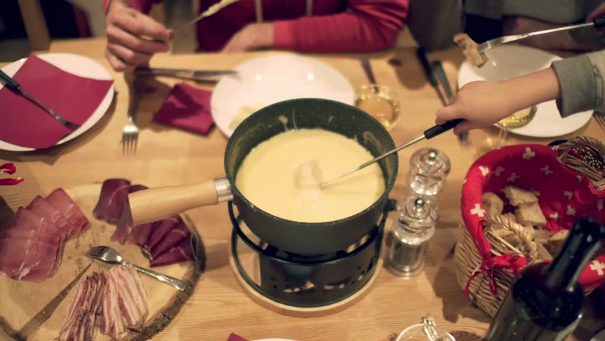 Fondue is a traditional Swiss dish that involves melting a mixture of cheese, chocolate, or other ingredients and using it for dipping various foods. The most popular type of fondue is cheese fondue.