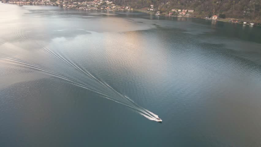 Aerial viewpoint of a boat at lake Lugano by Morcote, Ticino, Switzerland.