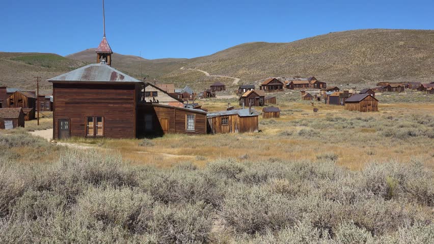 BODIE - 10.21.2024 - Exteriors of a run-down church and nearby homes in the ghost town of Bodie, California.