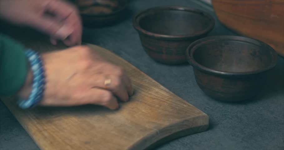 Home cooking. A man prepares a clay pot for cooking vegetables in the oven