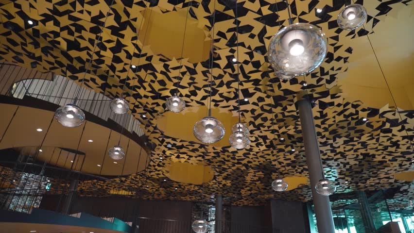 The interior of the House of Music Hungary with modern lighting and suspended glass globes, showcasing a stylish and artistic design